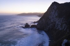 Nugget Point is a prominent headland on the Catlins coast in New Zealand. It is famous for its historic lighthouse and rocky islets known as "The Nuggets". Visitors can take an easy walk to a viewing platform for panoramic views of the ocean and the lighth