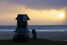 Photographer Rambo Estrada on the programme early during a spring swell at a remote beach break on the Catlins coast, Otago, New Zealand. Photo: Derek Morrison