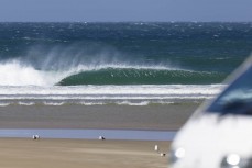 Sam Charlesworth making the most of a spring swell at a remote beach break on the Catlins coast, Otago, New Zealand. Photo: Derek Morrison