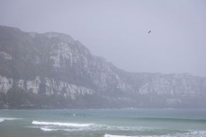 Rain squall at a remote beach break on the Catlins coast, Otago, New Zealand. Photo: Derek Morrison