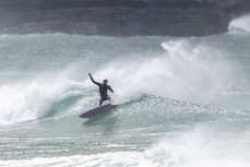 Sam Charlesworth making the most of a spring swell at a remote beach break on the Catlins coast, Otago, New Zealand. Photo: Derek Morrison