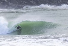 Josef Jungwirth gets tubed during a spring swell at a remote beach break on the Catlins coast, Otago, New Zealand. Photo: Derek Morrison