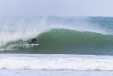 Keo Morrison gets a barrel in a spring swell at a remote beach break on the Catlins coast, Otago, New Zealand. Photo: Derek Morrison