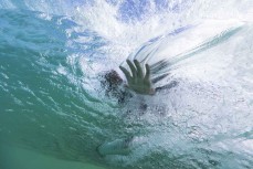 Keo Morrison hand in the wall during a fun swell at Blackhead, Dunedin, New Zealand. Photo: Derek Morrison