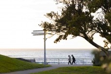 Dawn walkers at St Clair Beach, St Clair, Dunedin, New Zealand.