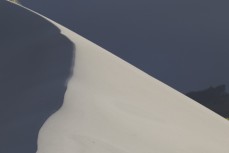 Sand dune in morning light at Smaills Beach, Dunedin, New Zealand.