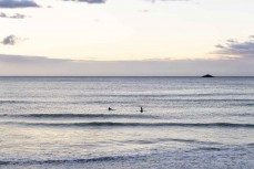 Dawn surfers at St Clair Beach, St Clair, Dunedin, New Zealand.