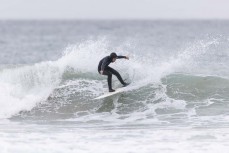 Young local grom makes the most of a small summer swell at Blackhead Beach, Dunedin, New Zealand.Photo: Derek Morrison