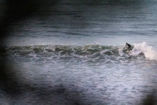 A surfer makes the most of a surprise swell on dusk at Belt Road, New Plymouth, Taranaki, New Zealand.