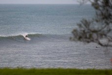 A surfer makes the most of a surprise swell on dusk at Belt Road, New Plymouth, Taranaki, New Zealand.
