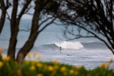 A surfer makes the most of a surprise swell on dusk at Belt Road, New Plymouth, Taranaki, New Zealand.