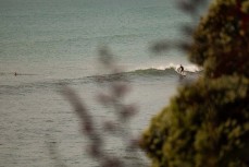 A surfer makes the most of a surprise swell on dusk at Belt Road, New Plymouth, Taranaki, New Zealand.