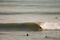 A surfer makes the most of a surprise swell on dusk at Belt Road, New Plymouth, Taranaki, New Zealand.