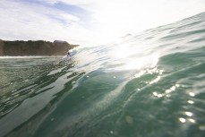Keo Morrison makes the most of a Christmas morning surf during a fun summer swell at Blackhead, Dunedin, New Zealand.