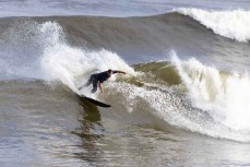 Local surfer Jack Raharuhi at the Westport Breakwater, Westport, West Coast, New Zealand.