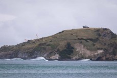 Remote empty lineup during a swell on the north coast of Dunedin, New Zealand.