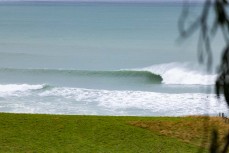 Remote empty lineup during a swell on the north coast of Dunedin, New Zealand.