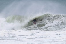 Muso Sam Charlesworth revelling in the juice during a swell on the north coast of Dunedin, New Zealand.