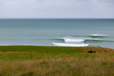 Remote empty lineup during a swell on the north coast of Dunedin, New Zealand.