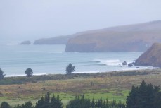 Remote empty lineup during a swell on the north coast of Dunedin, New Zealand.