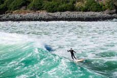 Skep down the line during a swell on the north coast of Dunedin, New Zealand.