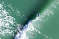 A surfer weaves down the line during a swell on the north coast of Dunedin, New Zealand.