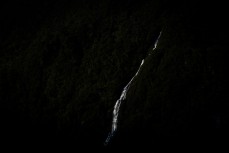 Water pours off the mountains during a tour exploring Doubtful Sound with Fiordland Expeditions Limited aboard the Tutoko II in Doubtful Sound, Fiordland, New Zealand. Photo: Derek Morrison
