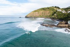 A surfer rides a wave at St Clair, Dunedin, New Zealand.