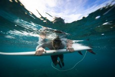 Brooke Bone peaking beneath the waves in the Mentawai Islands, Sumatra, Indonesia.
