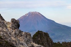 Mt Sinabung (2460m) comes into view during a climb of Mt Sibayak (2212m) near Bergastagi, Northern Sumatra, Indonesia.