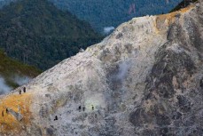 Visitors explore roaring sulphur-smelling vents during a climb of Mt Sibayak (2212m) near Bergastagi, Northern Sumatra, Indonesia.