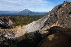Mt Sinabung (2460m) comes into view during a climb of Mt Sibayak (2212m) near Bergastagi, Northern Sumatra, Indonesia.
