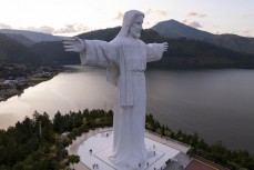 Giant statue of Jesus Christ overlooks Lake Toba from Sibebea Hill, Northern Sumatra, Indonesia.