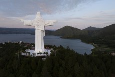 Giant statue of Jesus Christ overlooks Lake Toba from Sibebea Hill, Northern Sumatra, Indonesia.