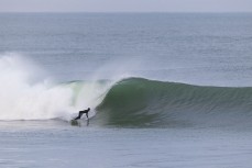 Luke Rogers during a winter swell at a remote beachbreak near Dunedin, New Zealand.Photo: Derek Morrison