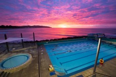 Dawn breaks over the Hot Saltwater Pool at St Clair Beach, Dunedin, New Zealand. 