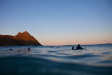 Surfers wait for a set at Blackhead Beach, Dunedin, New Zealand. 
