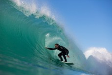 Simon Kaan rides in the barrel of a wave at Aramoana Beach, Dunedin, New Zealand. 