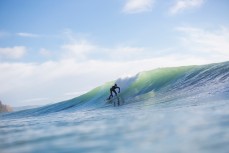 A surfer rides a wave at Aramoana, Dunedin, New Zealand. 