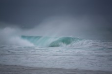 A hollow wave breaks on an east swell at St Kilda Beach, Dunedin, New Zealand.