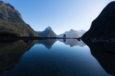 Travellers Ollie Shand and Coline Serra take in the views to Mitre Peak, Milford Sound, New Zealand. 