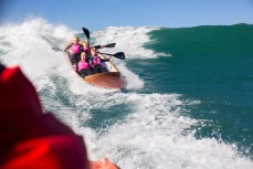 The Brighton Women's team wrestle a large wave during the 2014 White Island Race held by St Clair Surf Lifesaving Club at St Clair Beach, Dunedin, New Zealand on October 25, 2014. 