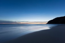 Sunset at an empty beach on Otago Peninsula, Dunedin, New Zealand. 