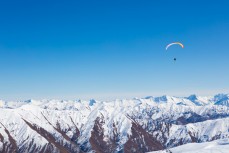 Freedom as a paraskier floats above the backcountry at Cardrona Alpine Resort, Wanaka, New Zealand. 