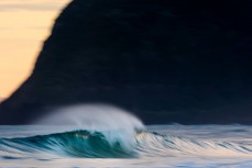 Clean hollow waves on dusk at St Kilda, Dunedin, New Zealand.