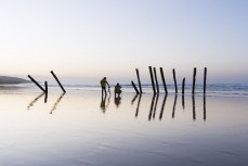 Photographers shoot the St Clair Poles at dawn, Dunedin, New Zealand. 